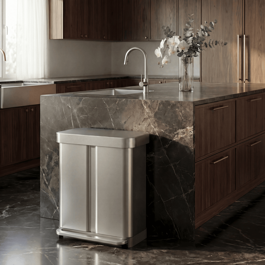Simplehuman's 58L Step Recycler in Brushed in a modern kitchen with wooden and marble cabinets and flooring with silver accents.