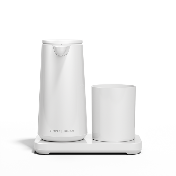 Low-angle view: Simplehuman White Foam Sensor Pump and Cup set on drip-free base.