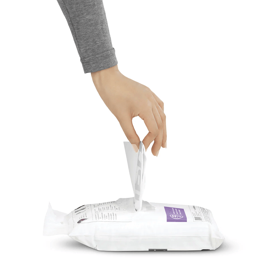 Hand pulling a single Simplehuman Code S trash liner from a white pouch.