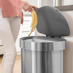 45L semi-round step can with liner rim - brushed finish - lifestyle lid open woman throwing away banana image
