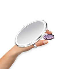 sensor mirror compact 10x - white finish - hand holding makeup image